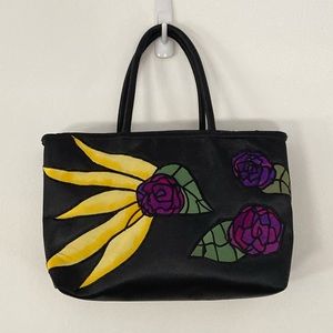 Black purse with yellow and purple flowers